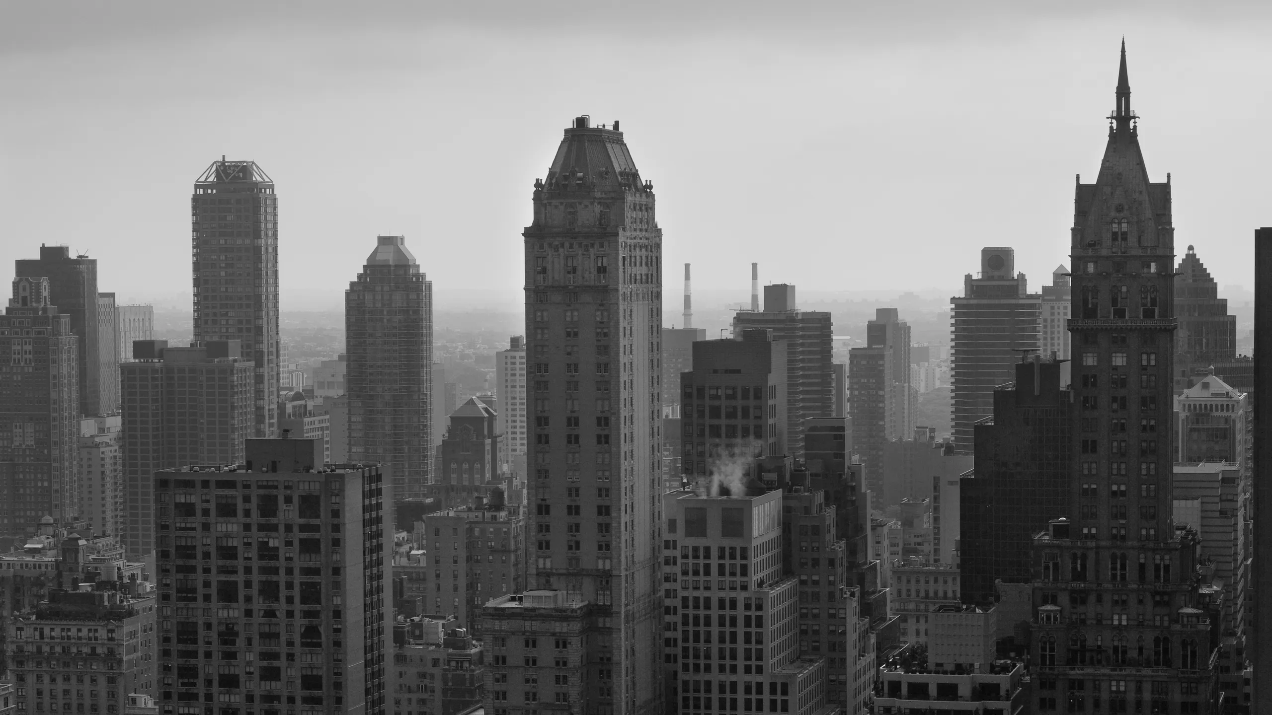 Black and white photo of a hazy city skyline with tall buildings